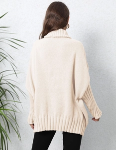Oversized cream knit turtleneck sweater with batwing sleeves and ribbed texture from back view