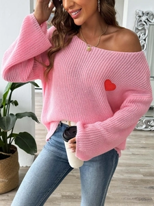 Close-up of red heart embroidery on pink off-the-shoulder knit sweater for women