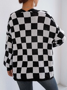 Dettaglio del cardigan in maglia a scacchi con polsini a costine e morbido tessuto