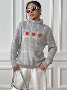 Women's grey turtleneck sweater with white grid patterns and red heart appliques