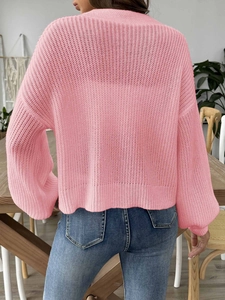 Back view of a pink crochet knit cardigan with hollow floral patterns and loose fit style