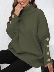 Detailed view of dark green knit sweater with decorative amber buttons on the sleeve