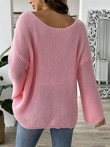 Detail of pink knitted sweater with open back design and hollow texture back view