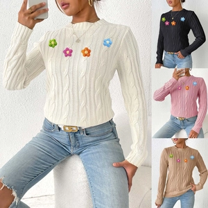 Detail of cable knit sweater featuring colorful 3D crochet flowers and diverse color options