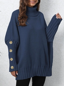 Detailed close-up of navy knit sweater sleeve with four decorative wooden buttons