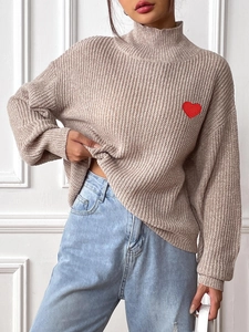 Beige high neck cable knit sweater with red heart embroidery patch and ribbed cuffs