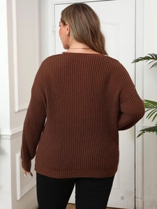 Close-up of the chunky ribbed knit texture and back detail of the brown sweater