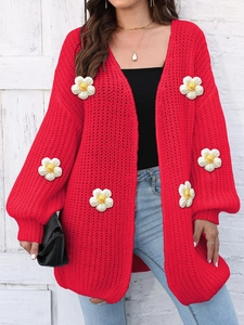 Detail of red chunky knit cardigan with 3D white daisy floral embroidery and buttons