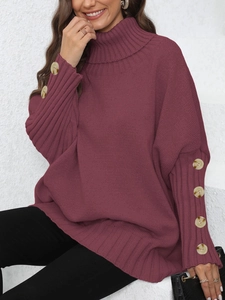 Detailed close-up of decorative buttons on the cuffs of a burgundy turtleneck sweater