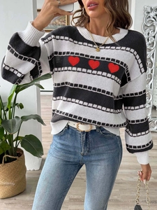 Women's striped crewneck knit sweater featuring three red heart patches on black and white