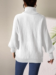 Detail of white high-neck knit sweater featuring a loose back silhouette and ribbed texture