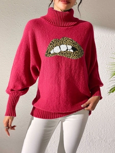 Detail of red turtleneck sweater featuring leopard print lips and puff sleeves