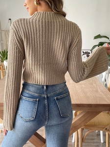 Detailed back view of khaki chunky knit sweater with flare sleeves and cropped fit design