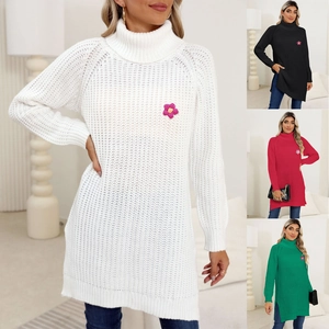 Detail of high neck knit dress featuring a 3D floral accent and stylish side slits