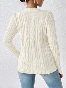 Detail view of the cable knit pattern on the back of this cream crewneck sweater