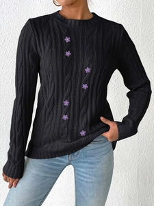 Women's black cable-knit sweater with purple flower embroidery and crew neckline