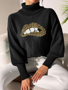 Detail of sequin leopard lip embroidery on black turtleneck sweater with balloon sleeves