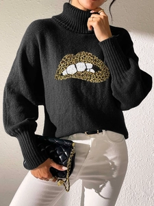 Detail of black turtleneck sweater with leopard print lip pattern and ribbed cuffs