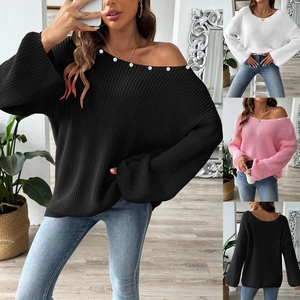 Detail of elegant off-shoulder knit sweater with delicate pearl embellishments on neckline
