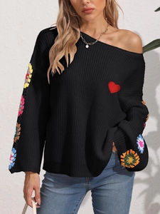 Women's off-shoulder black knit sweater with colorful crochet floral sleeves and heart patch