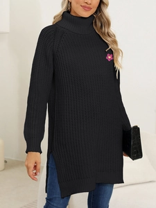 Detail of black turtleneck knit dress featuring a pink floral embroidery and side slits