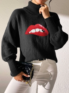 Detailed close-up of sequined red lip embroidery on a black turtleneck sweater