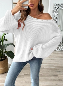 Detail of off-shoulder knit sweater with pearl beads and wide flare sleeves design