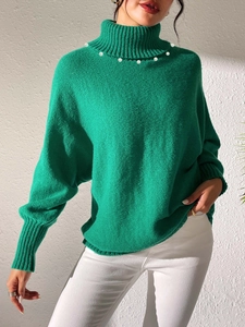 Detail of high neck knit sweater featuring elegant pearl collar and rib knit texture
