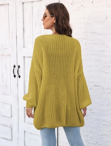 Detail view of mustard yellow oversized knit cardigan with chunky texture and drop shoulders