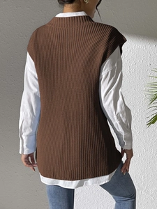 Back view of a woman wearing a dark brown knitted V-neck vest over a white collared shirt