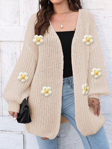 Women's beige oversized chunky knit cardigan featuring 3D white daisy floral appliqués