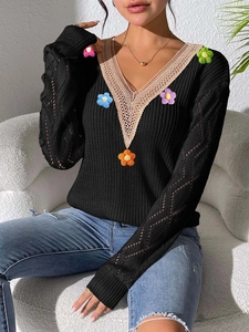 Detailed close-up of V-neck lace patchwork and colorful crochet floral knit embroidery