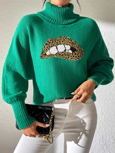 Detail of sequined leopard print lip embroidery on green turtleneck lantern sleeve sweater