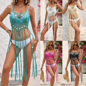 Detail of crochet beach cover-up with sequins and long tassels in multiple colors