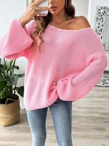 Detail of pink off-shoulder sweater showing elegant pearl beads along the neckline