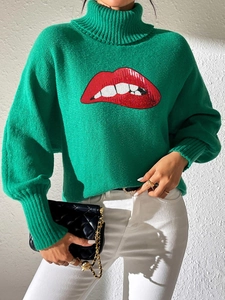 Detail of sequined red lip pattern on bright green turtleneck knit sweater for women