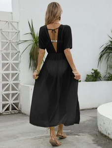 Detail of sheer black beach cover-up with open back and ribbon bow tie at the waist
