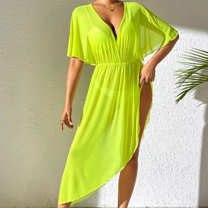 Detail view of neon green sheer beach cover-up with deep V-neck and high side slit