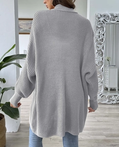 Rear view of long loose gray knit cardigan featuring thick ribbed cuffs and high neck style