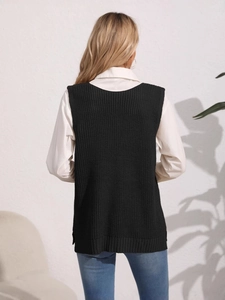 Back view of a black knitted V-neck vest layered over a white long-sleeve shirt