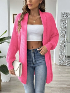 Detail shot of hot pink knit cardigan featuring crochet stitching and loose casual fit