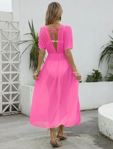 Detailed back view of a sheer bright pink mesh beach cover-up with tie-back waist design