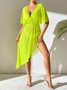 Close-up of neon yellow mesh beach cover-up with deep V-neck and ruffled batwing sleeves