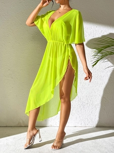 Detail of neon yellow chiffon beach cover-up featuring deep V-neck and elastic waist