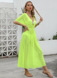 Detail of neon yellow mesh beach cover-up with deep V-neck and high side slits