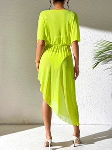 Rear view of neon green sheer beach cover-up with elastic waist and ruffle hem