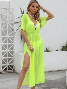 Detail of neon green mesh beach cover-up featuring deep V-neck and high side slit