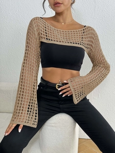 Detail of hollow out knit beach cover up with beige textured crochet stitch pattern