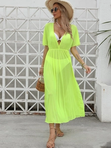 Detail of neon green sheer mesh beach cover-up with deep V-neck and elastic waist