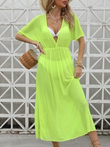 Detail of neon green sheer mesh beach cover-up with deep V-neck and cinched waistline